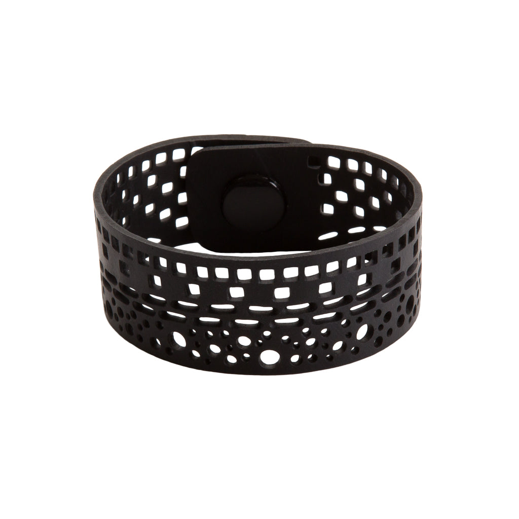 Paguro Upcycle black recycled rubber bracelet with perforated geometric design and snap closure