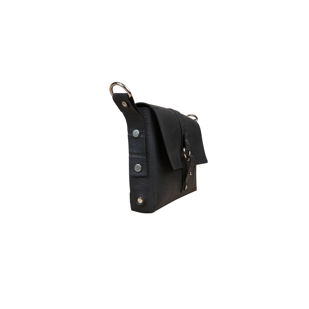 Paguro Upcycle black vegan handbag with silver hardware and flap closure in side view