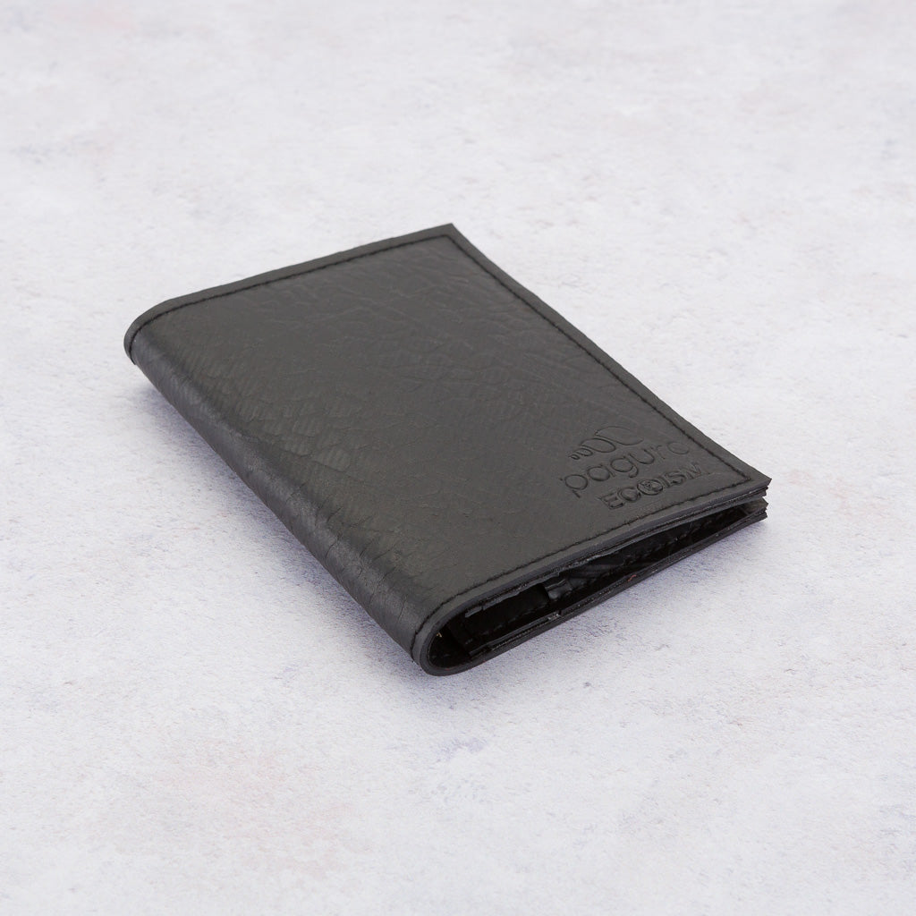 Black Paguro Upcycle recycled rubber wallet with textured surface folded on a light background