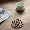 Paguro Upcycle Japanese pattern drink coasters made of wood with geometric cutout design on wooden table