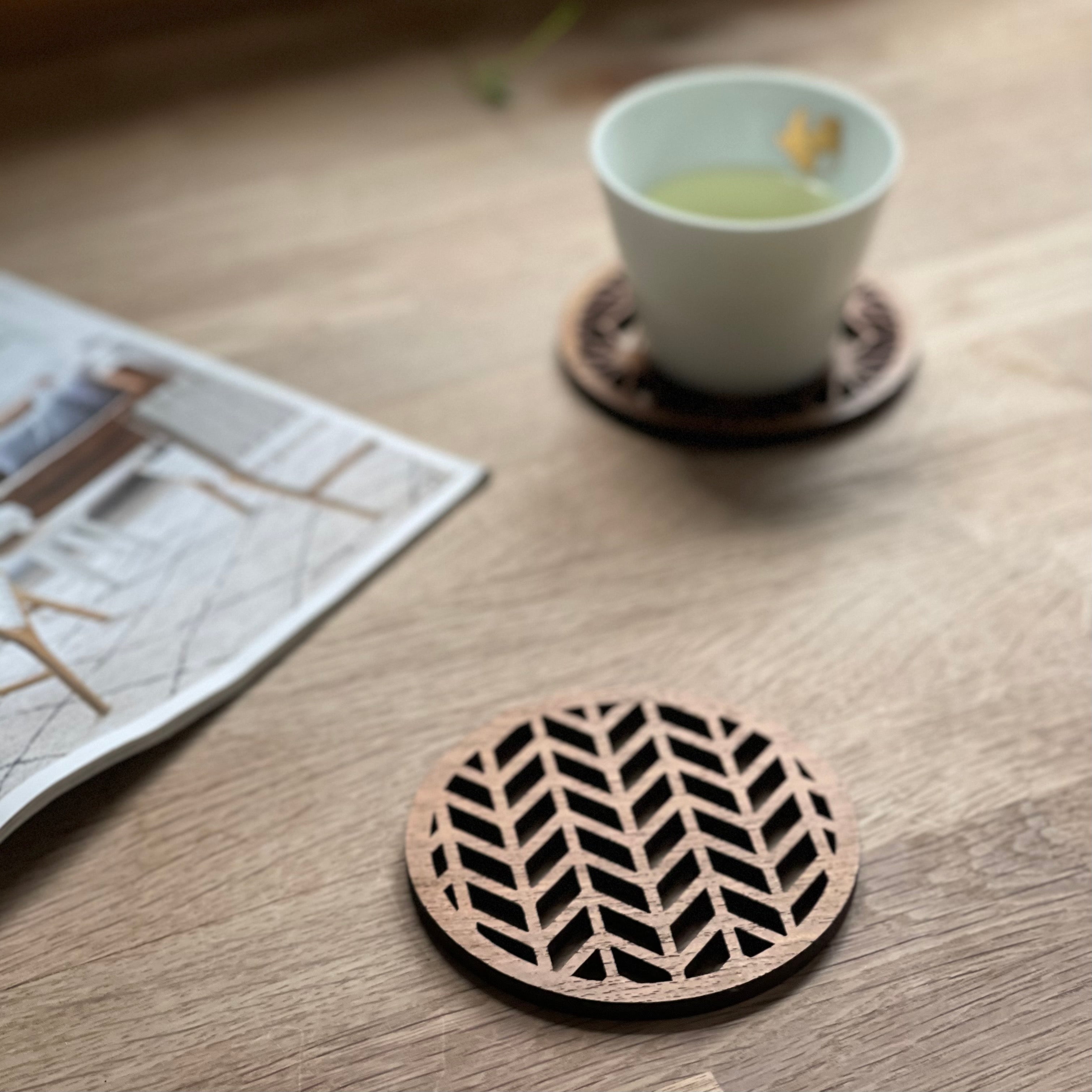 Paguro Upcycle Japanese pattern drink coasters made of wood with geometric cutout design on wooden table