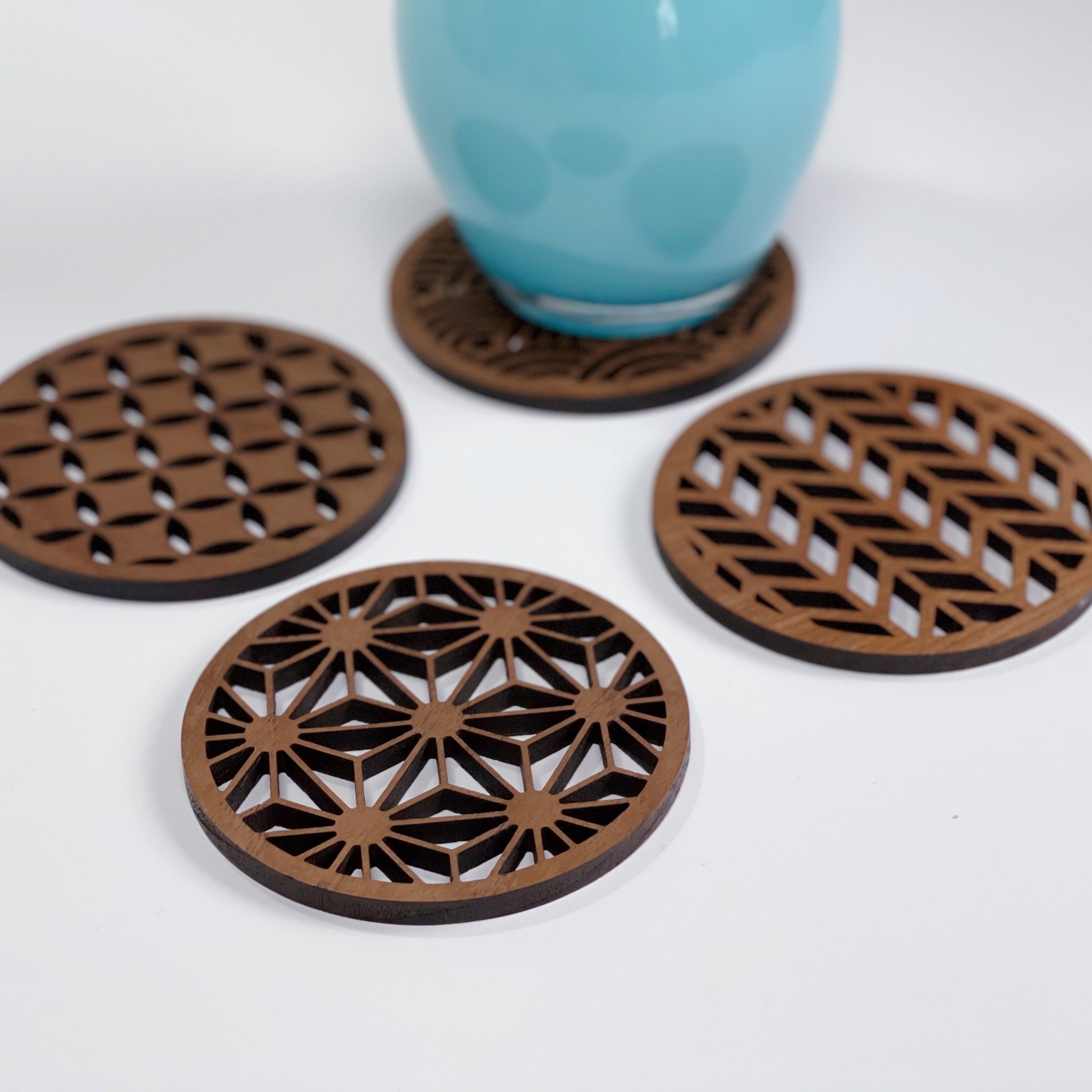 Paguro Upcycle Japanese pattern drink coasters with intricate geometric designs under a blue cup