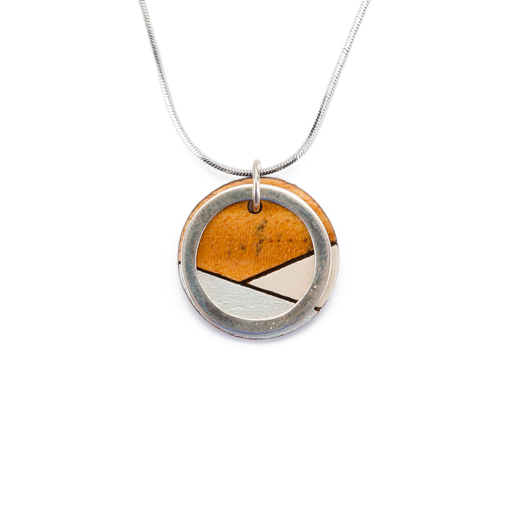 Paguro Upcycle recycled wood silver necklace with circular pendant and geometric design on silver chain