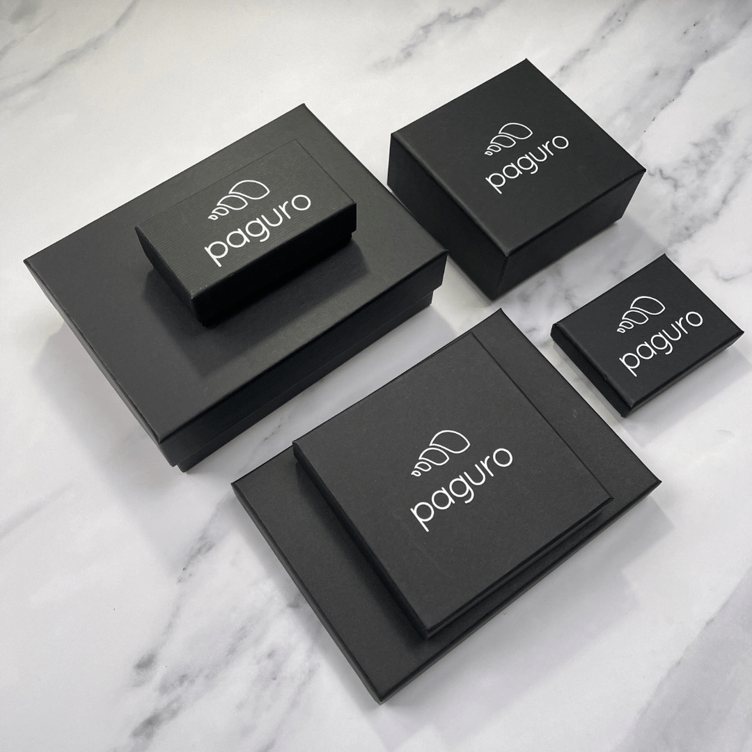 Paguro Upcycle packaging boxes for vegan wallet made from inner tube on marble surface