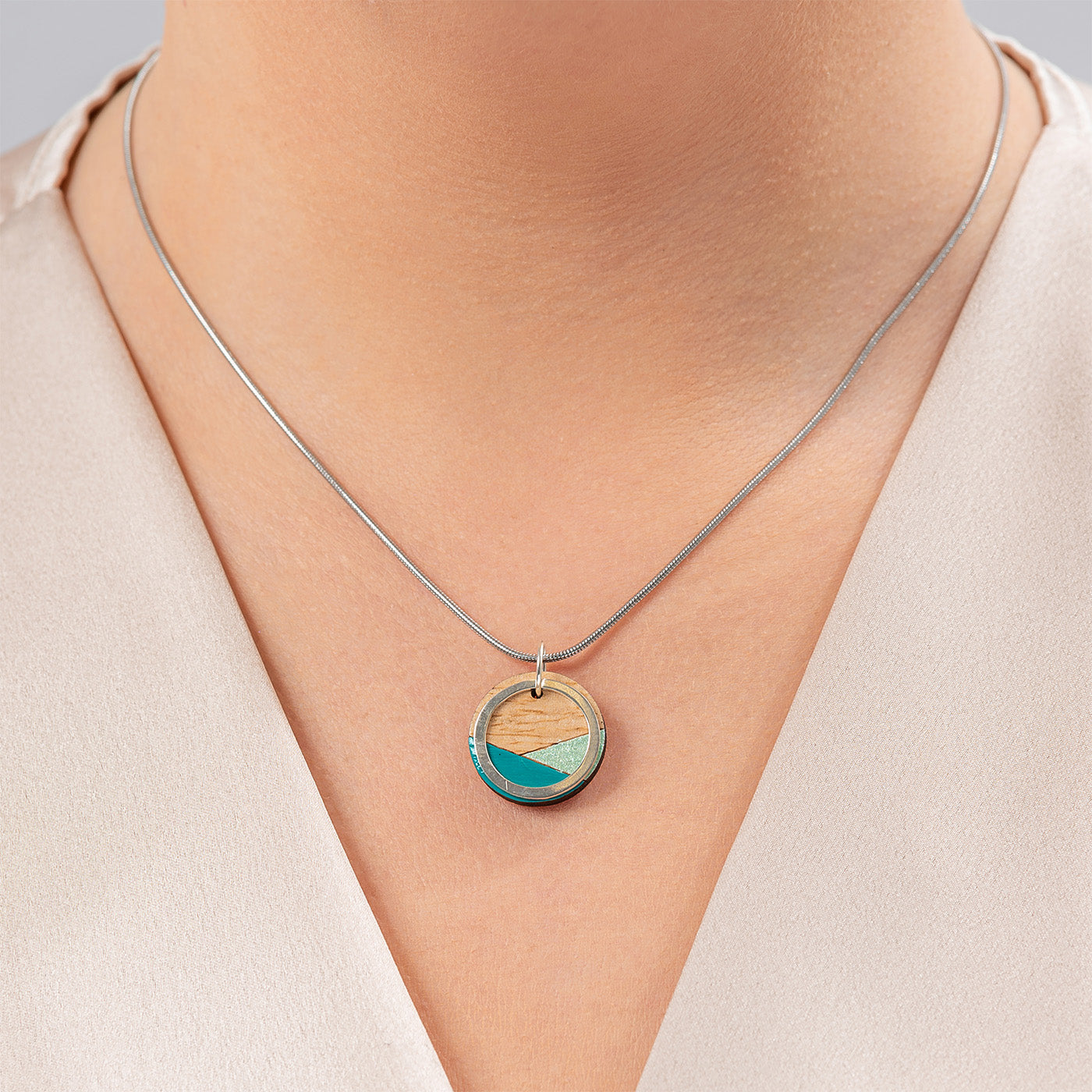 Paguro Upcycle recycled wood silver necklace with round pendant featuring turquoise and natural wood design