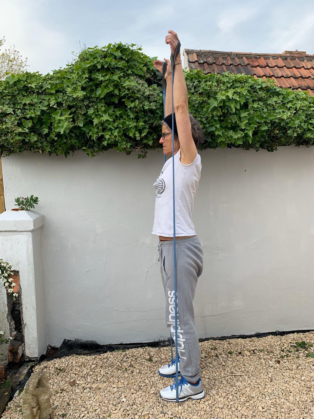 Woman exercising outdoors using Paguro Upcycle upcycled resistance band from bicycle inner tube for stretching