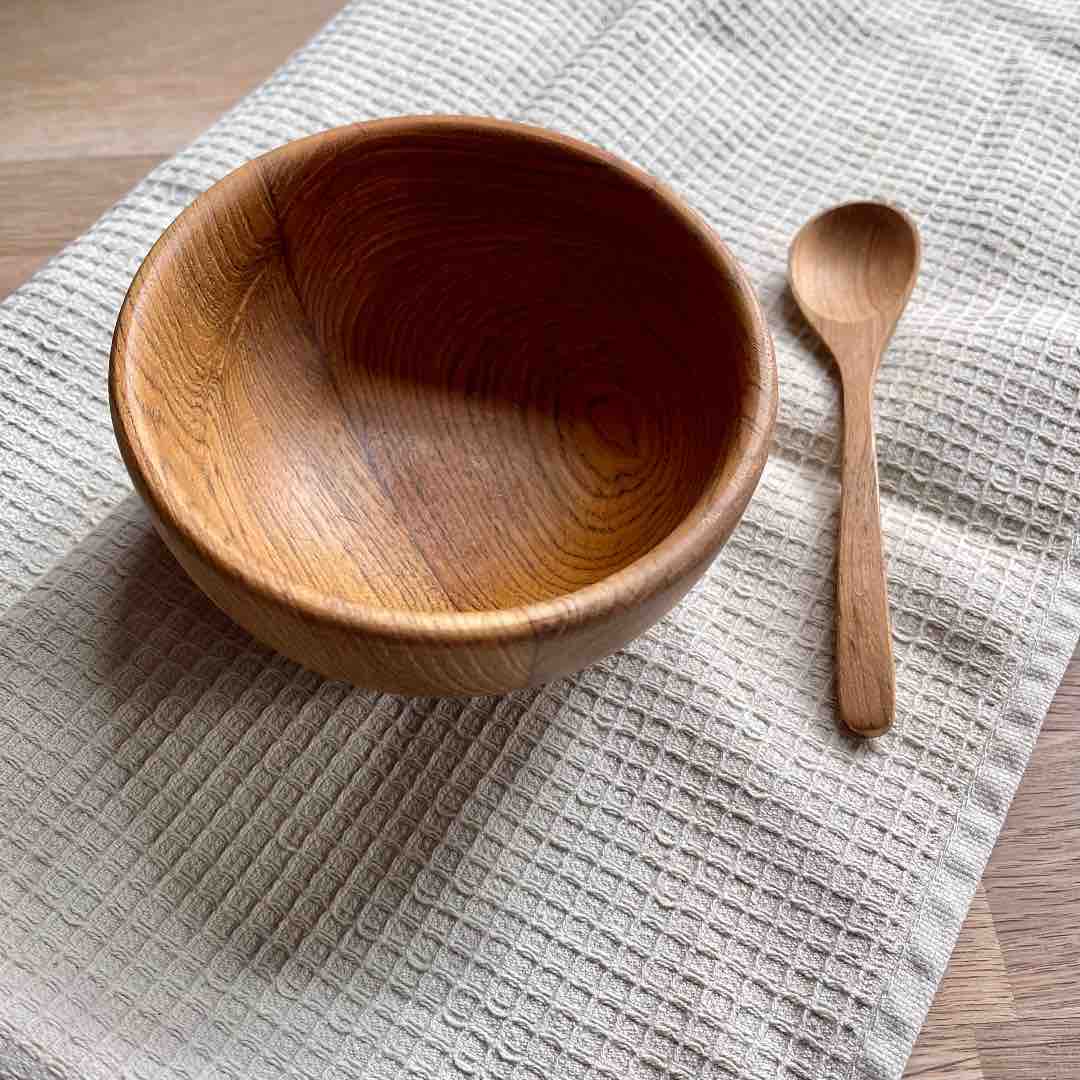 Paguro Upcycle upcycled wooden spoon next to a wooden bowl on textured cloth