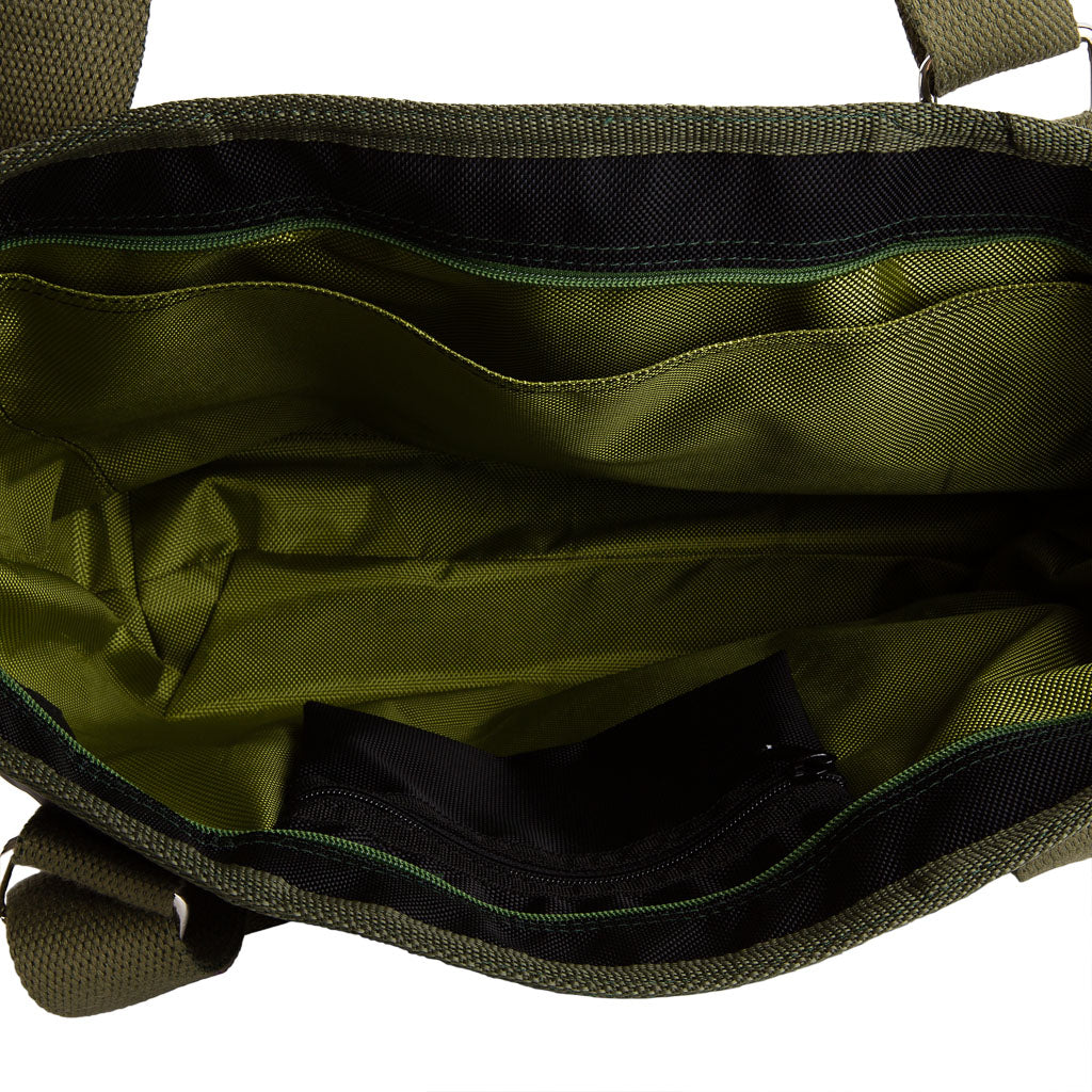 Interior view of vegan tote bag made from inner tube by Paguro Upcycle showing green fabric lining and zippered pocket