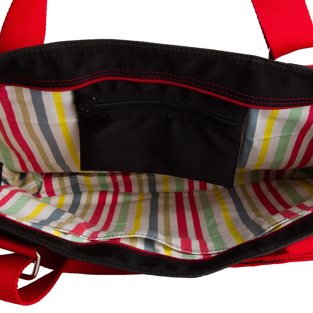 Interior view of vegan tote bag made from inner tube with colorful striped lining and black zip pocket